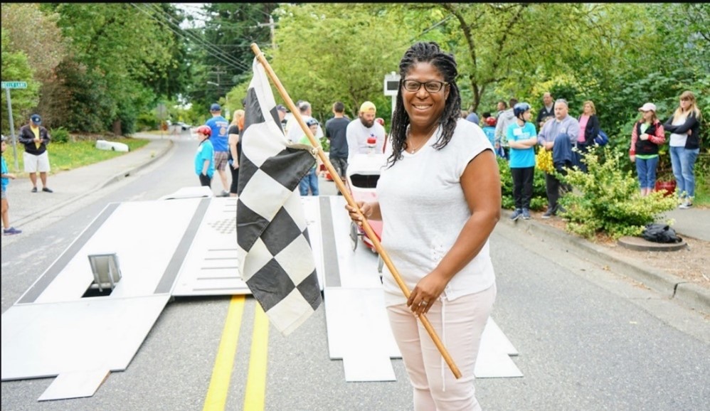 Sydne Mullings hold the checkered flag at the soapbox derby.